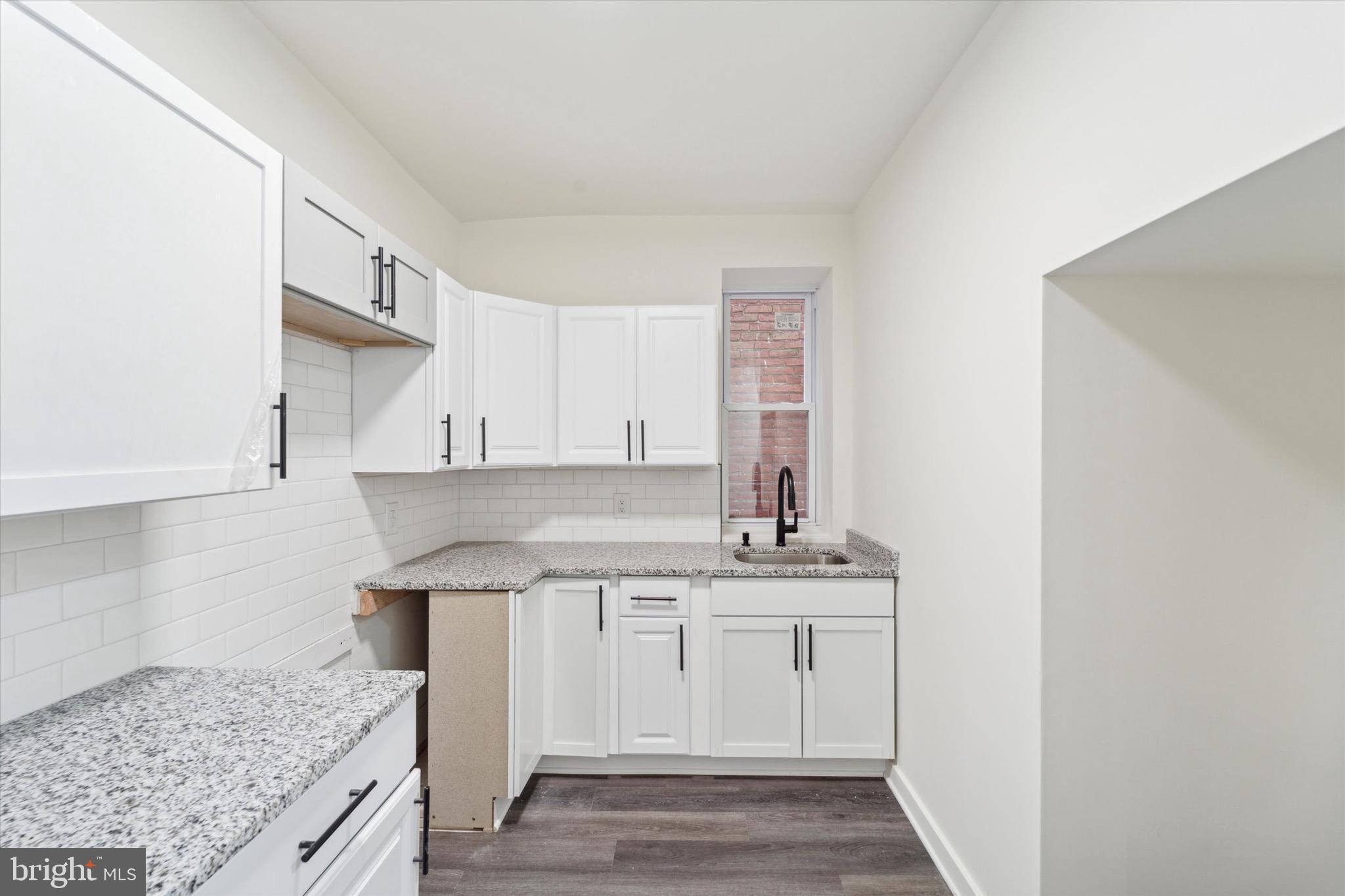 316 East 11th Street Chester, PA 19013 - Photo 9 of 28 a kitchen with a sink stove and cabinets
