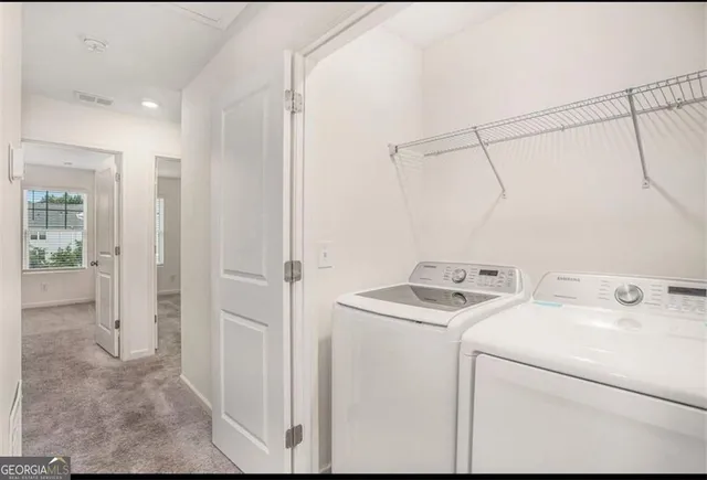 a utility room with dryer and washer
