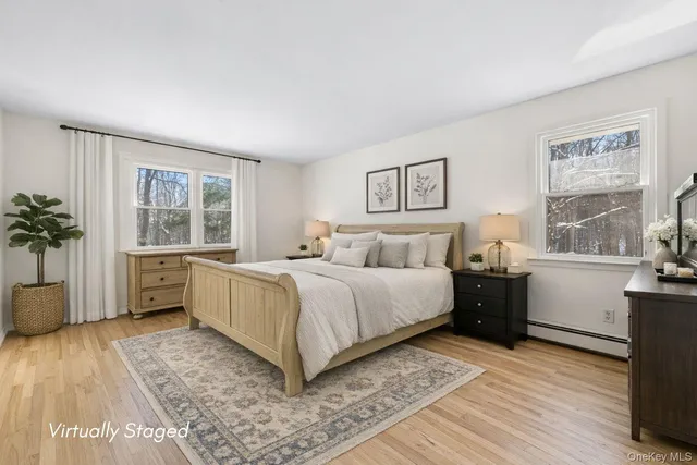 a bedroom with a large bed and a window