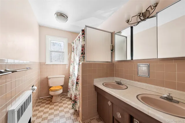 a bathroom with a sink toilet a mirror and shower