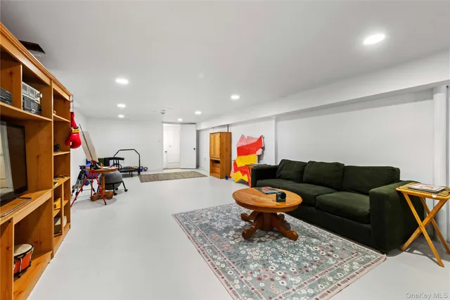 a living room with furniture a rug and a flat screen tv