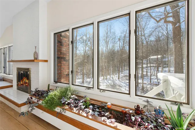 a living room with garden view and a fireplace