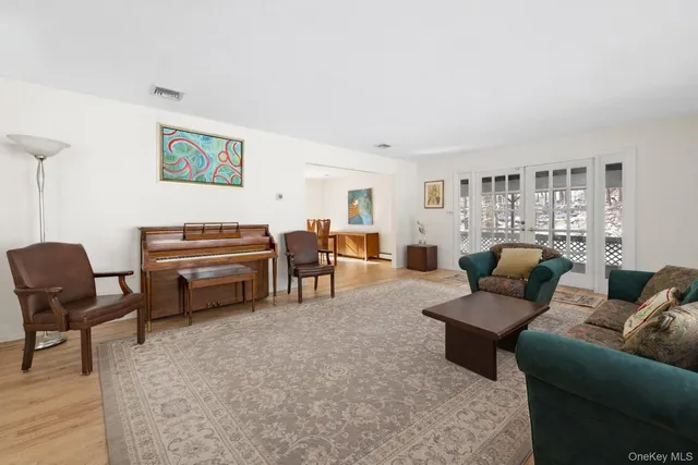 a living room with furniture and a piano