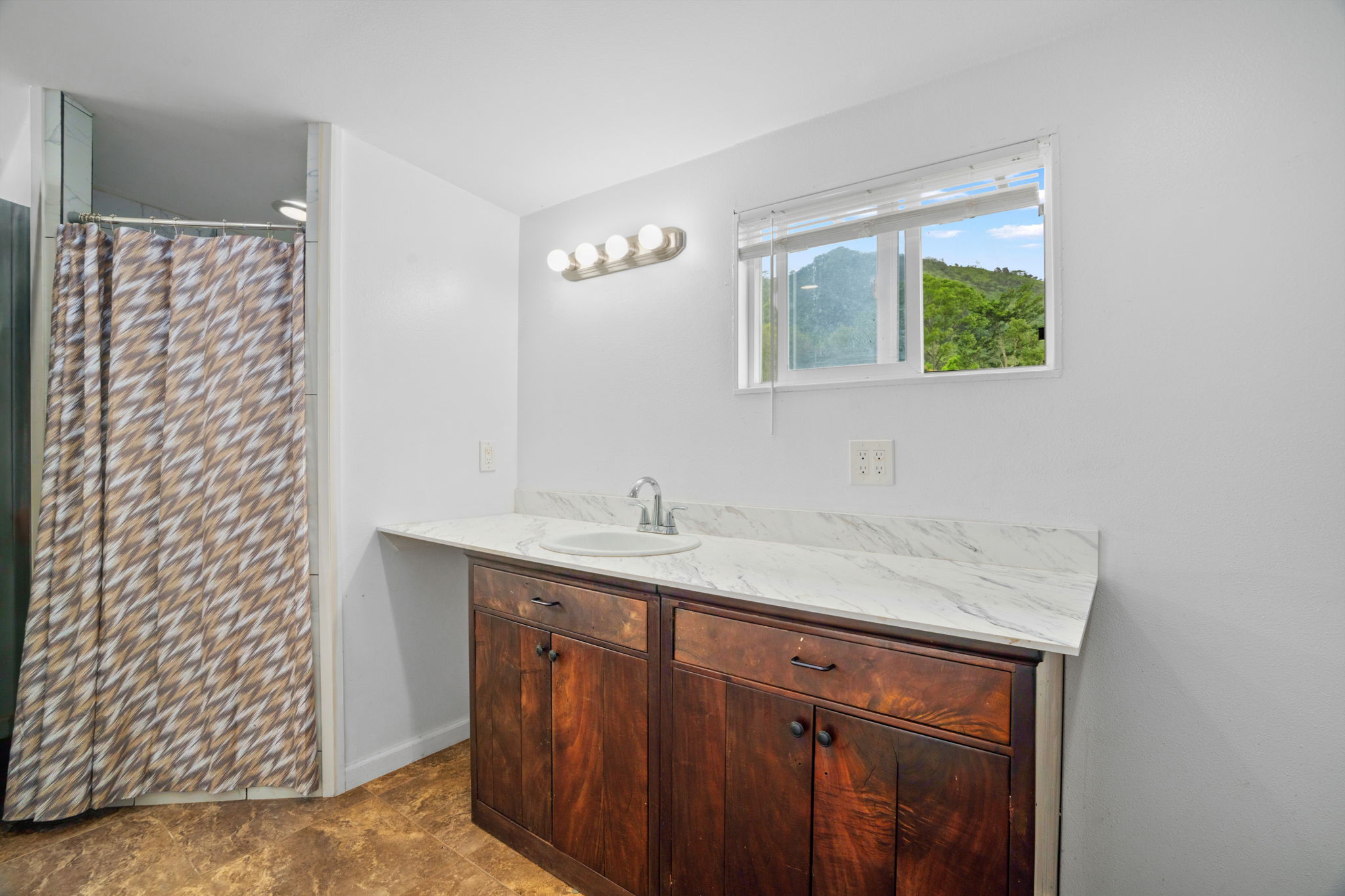 7060 Kahuna Road Kapaa, HI 96746 - Photo 14 of 30 a bathroom with a granite countertop sink a mirror and a shower