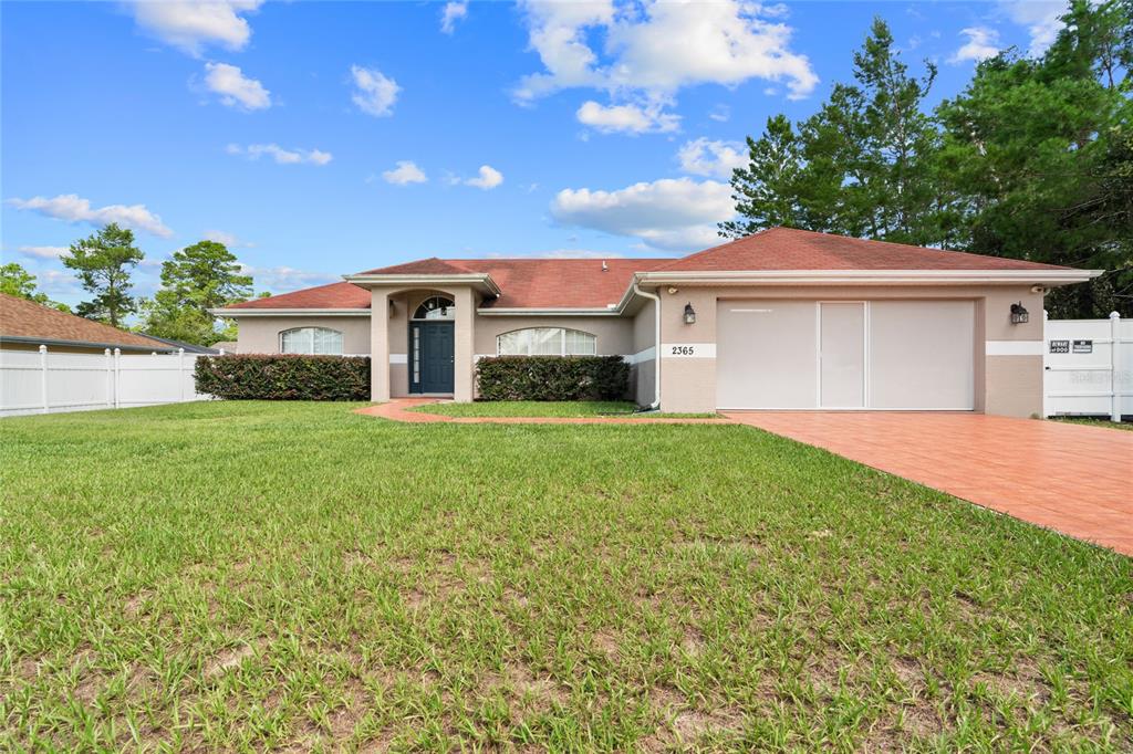 2365 Southwest 159th Lane Ocala, FL 34473 - Photo 1 of 1 a front view of a house with a garden