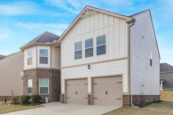 a view of a house with a garage and balcony