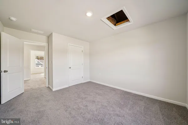 an empty room with closet and bathroom view