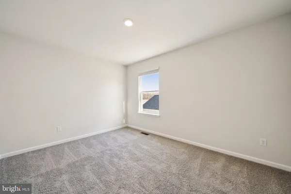 a view of an empty room and a window