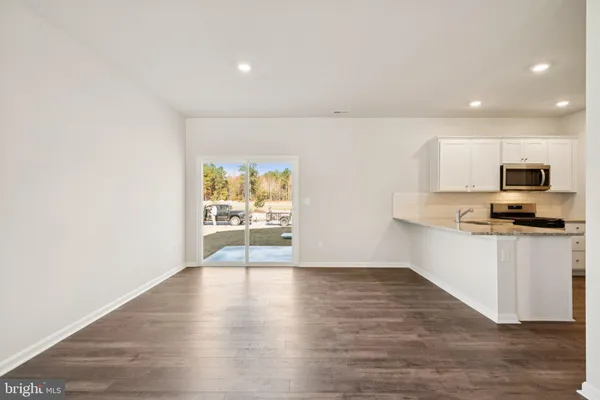 a view of kitchen with microwave and wooden floor