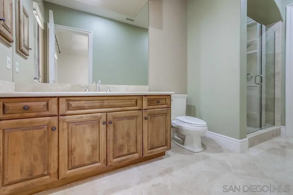 14175 Biscayne Place Poway, CA 92064 - Photo 35 of 65 a bathroom with a toilet a sink and mirror