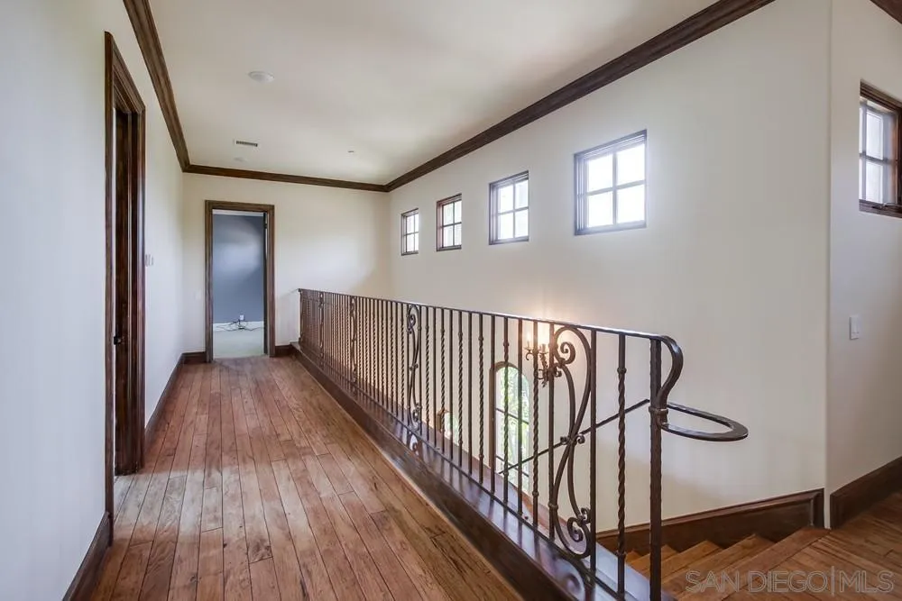 14175 Biscayne Place Poway, CA 92064 - Photo 39 of 65 a view of a hallway with wooden floor and stairs