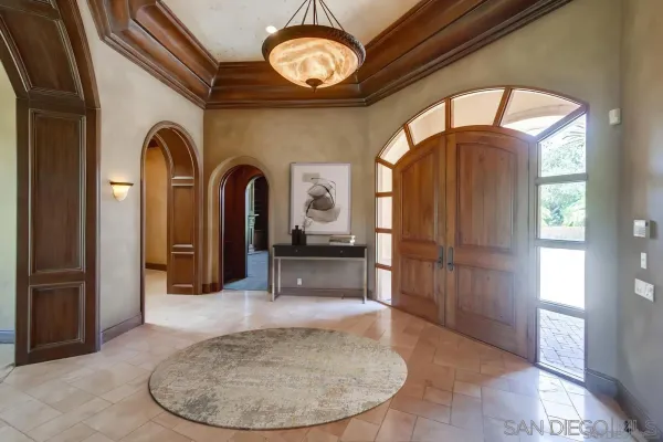 a view of a hallway with entryway wooden floor and front door