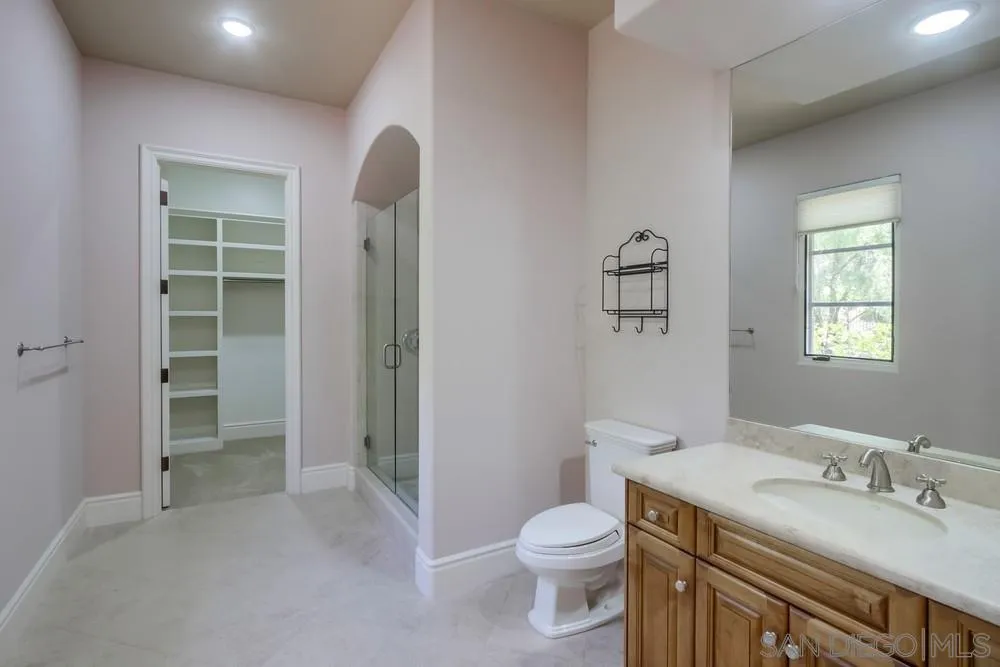 14175 Biscayne Place Poway, CA 92064 - Photo 60 of 65 a bathroom with a granite countertop sink a toilet and a shower