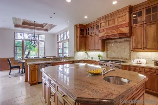 a kitchen with granite countertop a sink and a stove