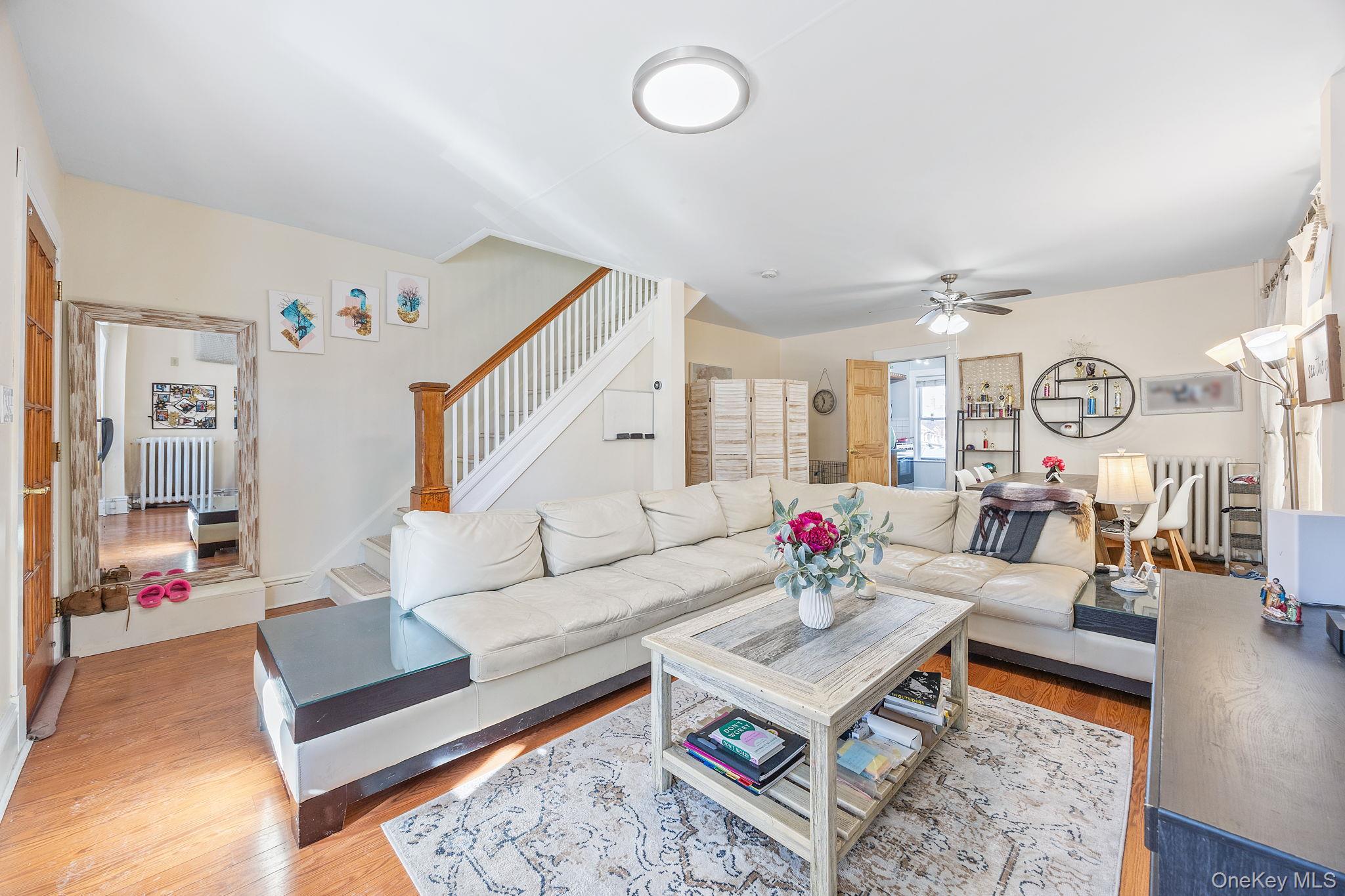 72-15 Juniper Valley Road Queens, NY 11379 - Photo 2 of 15 a living room with furniture and wooden floor