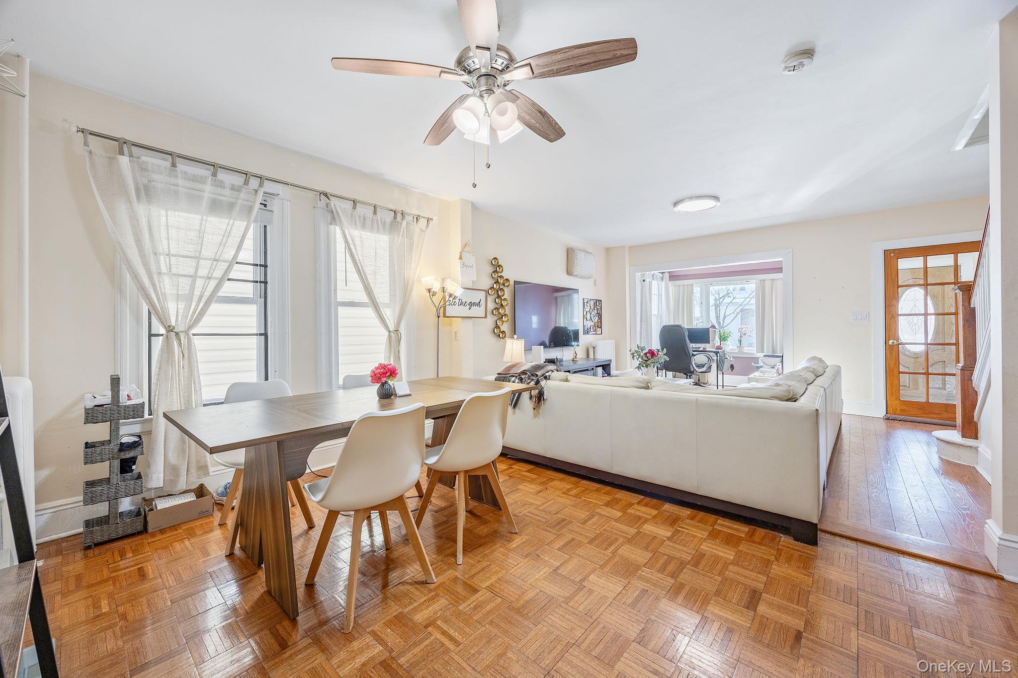 72-15 Juniper Valley Road Queens, NY 11379 - Photo 4 of 15 a living room with a table chairs and a dining table