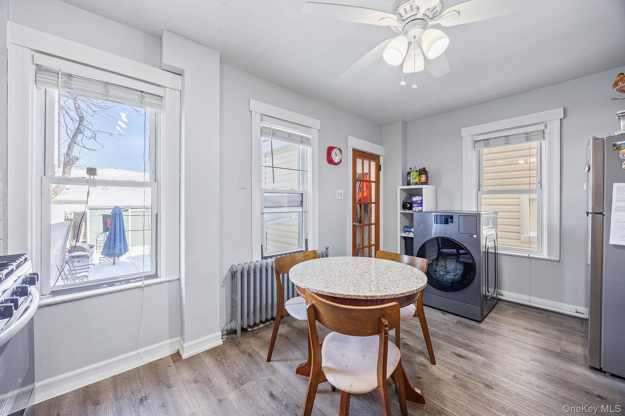 72-15 Juniper Valley Road Queens, NY 11379 - Photo 6 of 15 a view of a dining room with furniture window and wooden floor