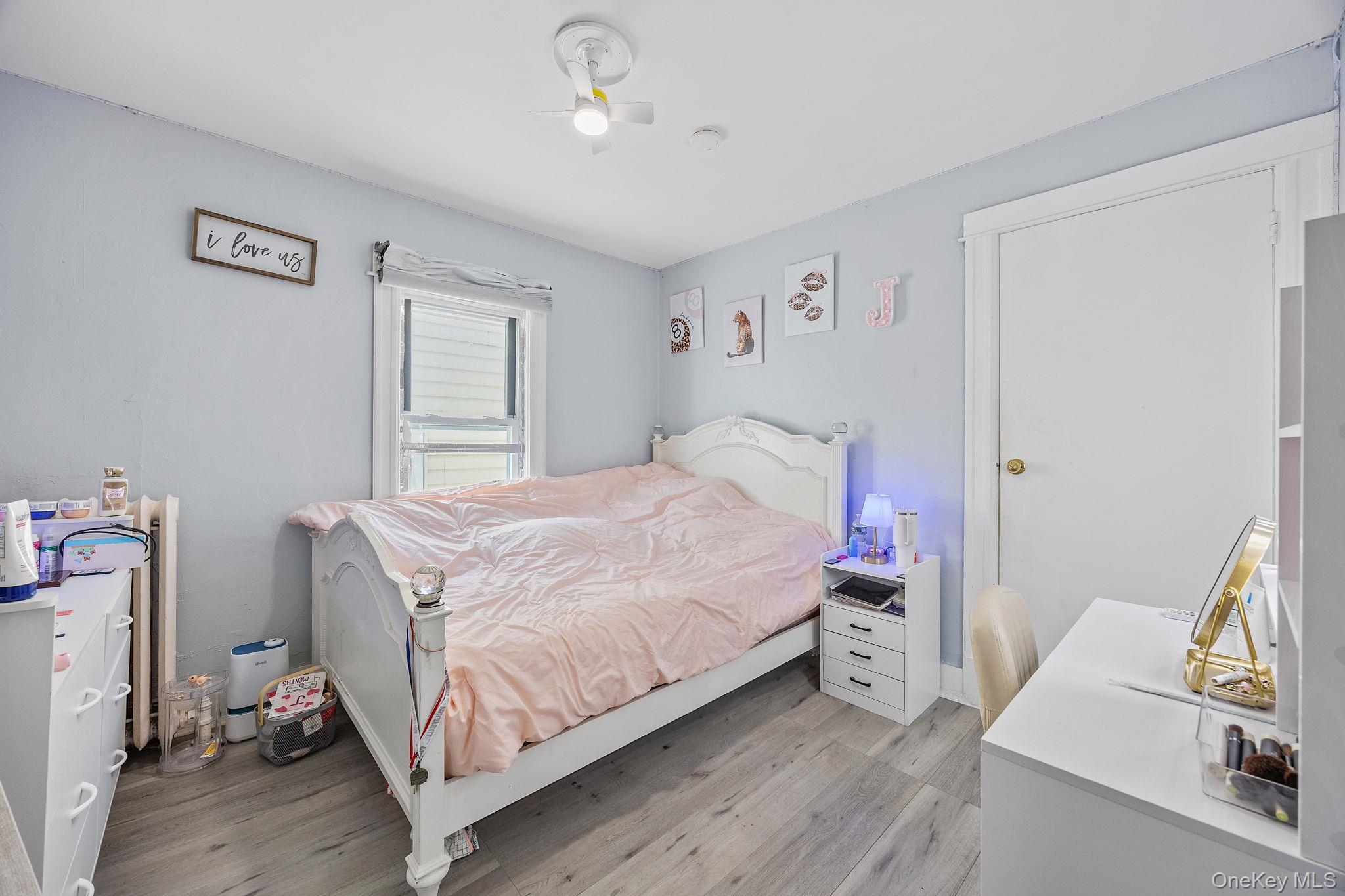 72-15 Juniper Valley Road Queens, NY 11379 - Photo 9 of 15 a bedroom with a bed and wooden floor