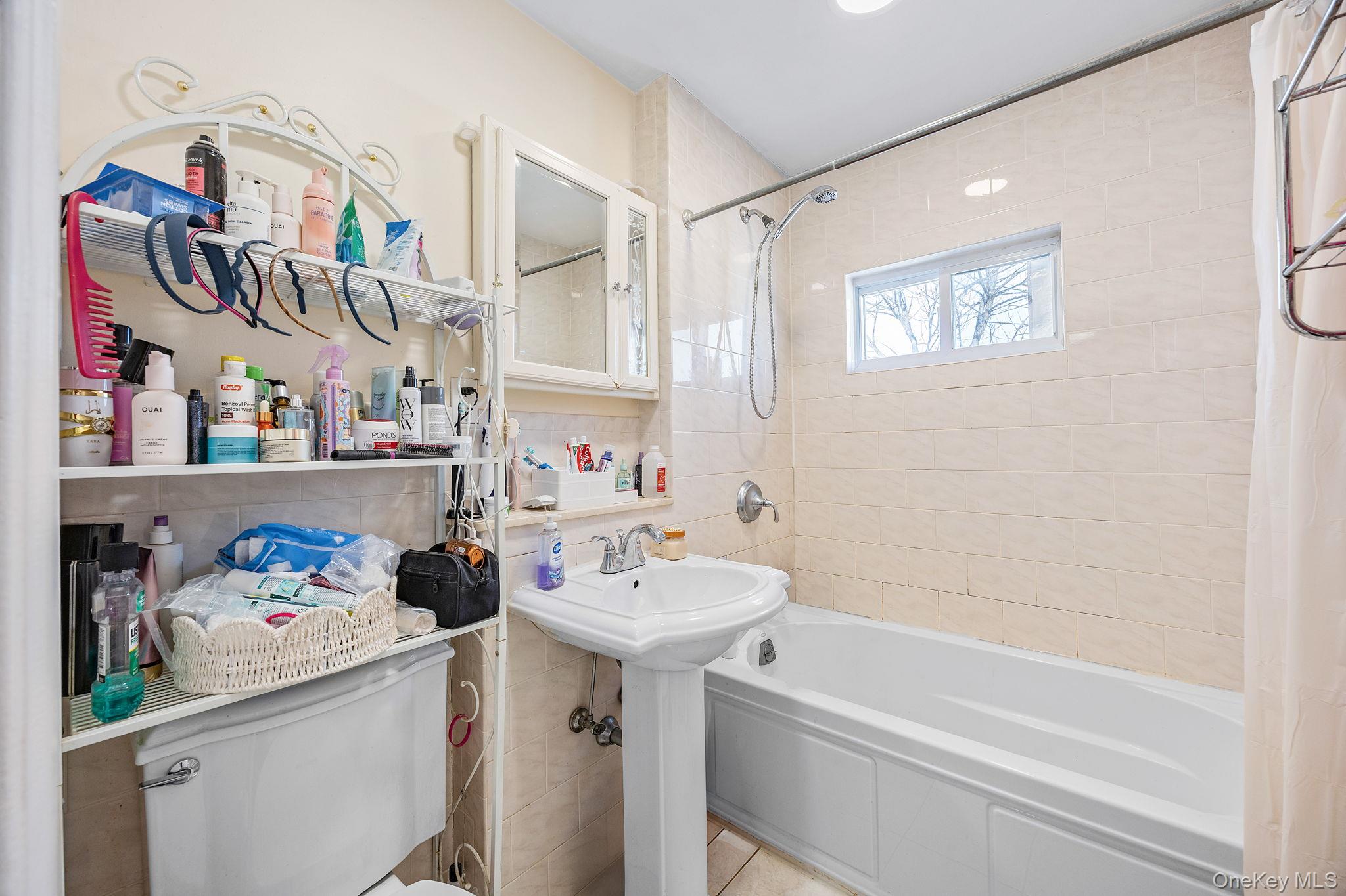 72-15 Juniper Valley Road Queens, NY 11379 - Photo 10 of 15 a bathroom with a sink and a mirror