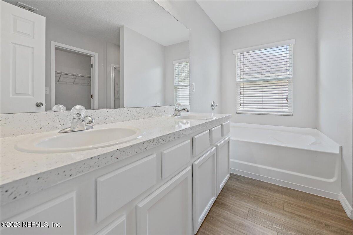 4046 Trail Ridge Road Middleburg, FL 32068 - Photo 11 of 22 a bathroom with a sink double vanity granite tub and a window
