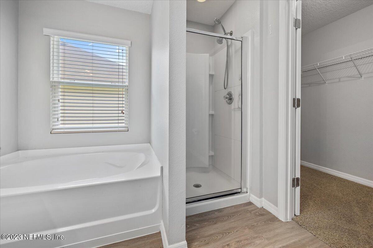 4046 Trail Ridge Road Middleburg, FL 32068 - Photo 12 of 22 a bathroom with a bathtub and a shower