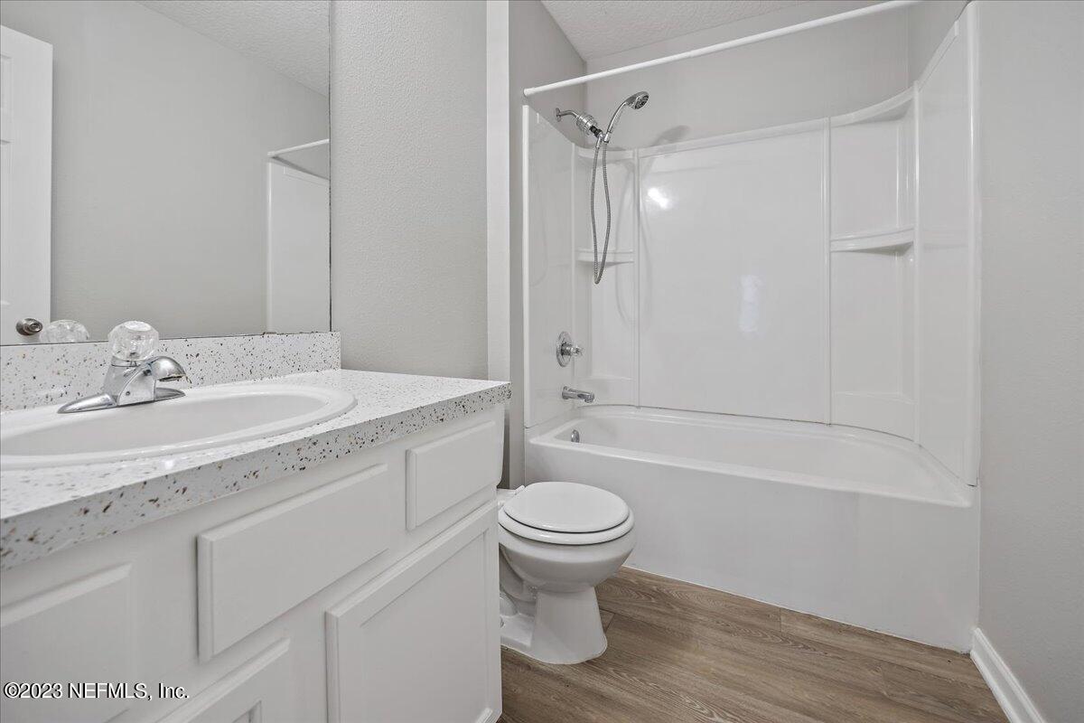 4046 Trail Ridge Road Middleburg, FL 32068 - Photo 15 of 22 a bathroom with a sink a toilet and a large mirror