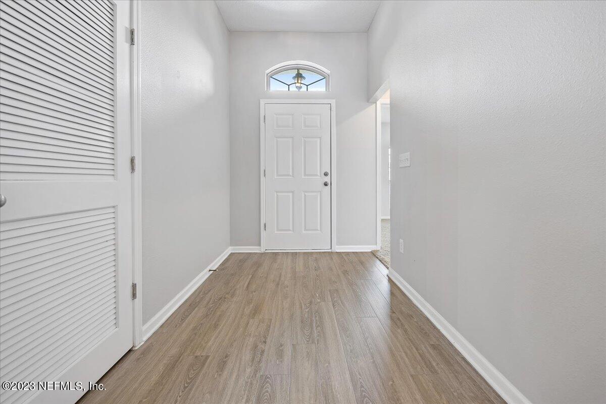 4046 Trail Ridge Road Middleburg, FL 32068 - Photo 3 of 22 a view of a hallway with wooden floor