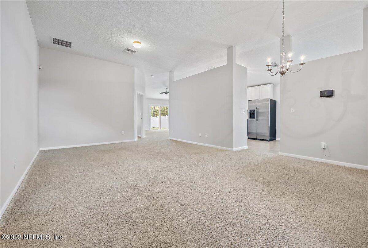 4046 Trail Ridge Road Middleburg, FL 32068 - Photo 4 of 22 a view of a big room with chandelier fan and windows