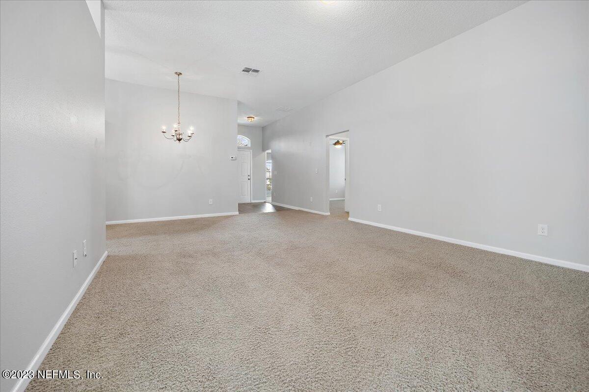 4046 Trail Ridge Road Middleburg, FL 32068 - Photo 5 of 22 an empty room with a empty space and a ceiling fan