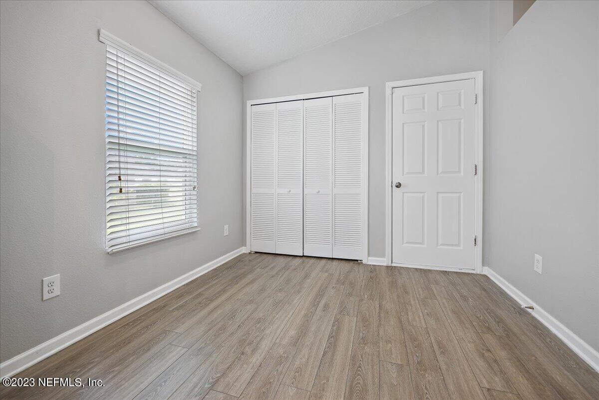 4046 Trail Ridge Road Middleburg, FL 32068 - Photo 8 of 22 a view of an empty room with wooden floor and a window