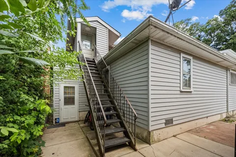 a backyard of a house with table and chairs