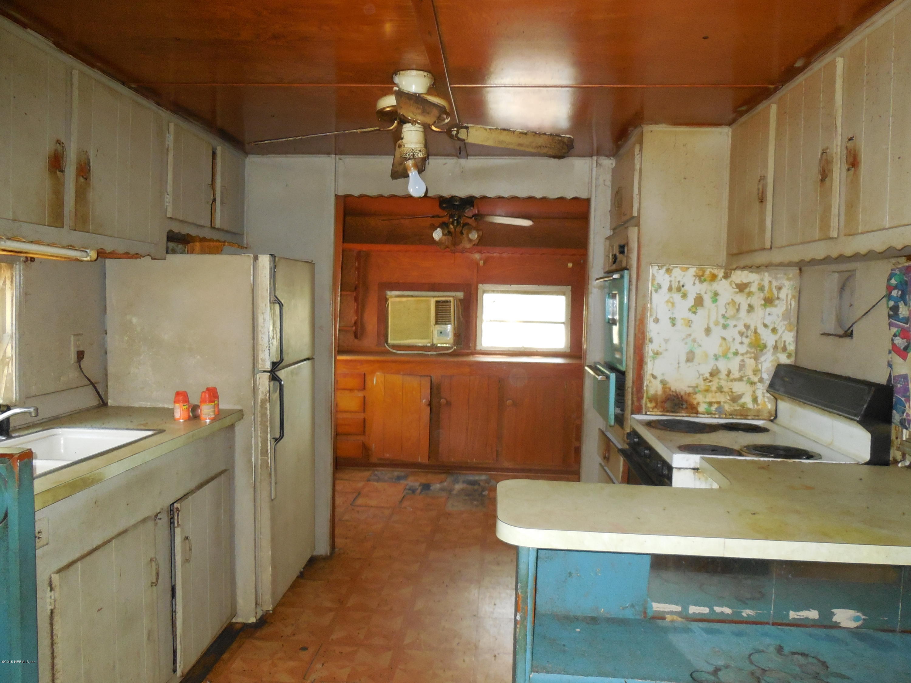 158 Oak Run Road Crescent City, FL 32112 - Photo 11 of 18 a kitchen with refrigerator and window