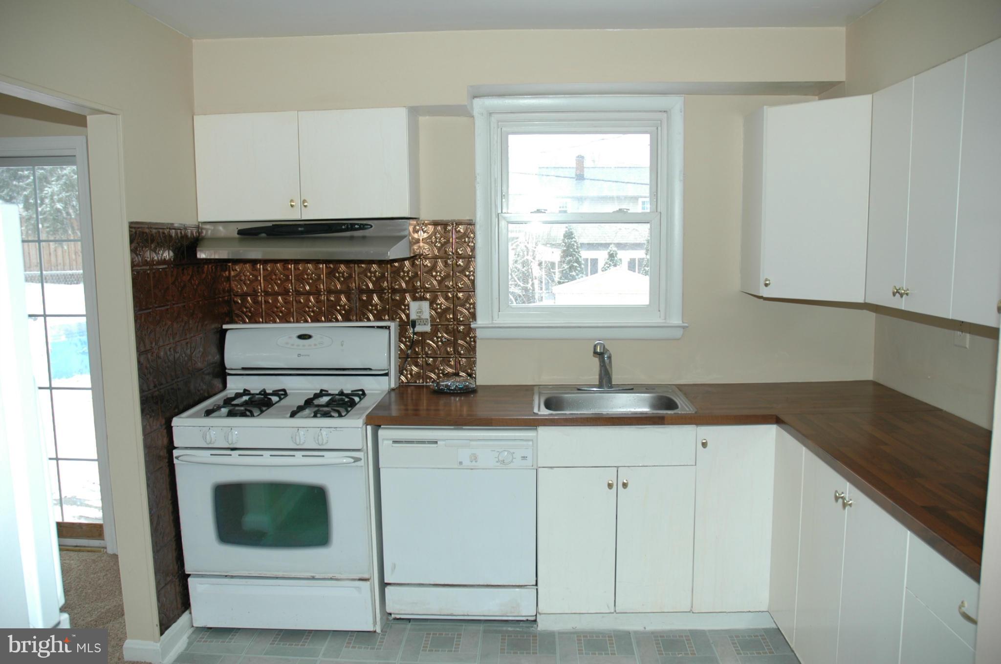 103 Mountain Road Linthicum, MD 21090 - Photo 6 of 17 a kitchen with granite countertop a sink a stove and cabinets