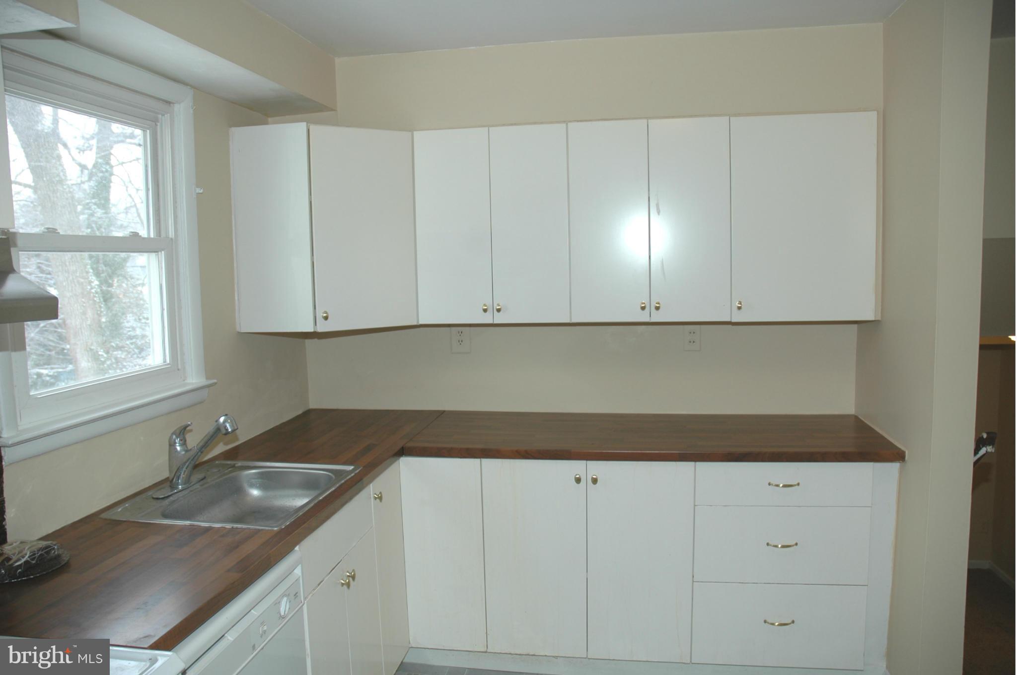 103 Mountain Road Linthicum, MD 21090 - Photo 7 of 17 a kitchen with granite countertop white cabinets and a sink