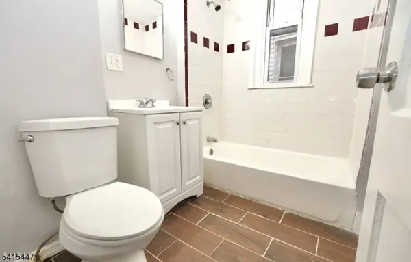 a bathroom with a toilet and a bathtub
