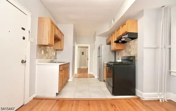 a kitchen with a refrigerator and a stove