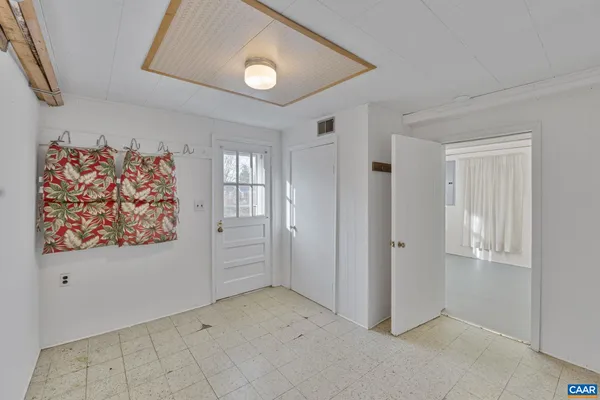 an empty room with windows and closet