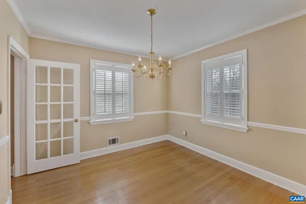 a view of a room with windows and chandelier