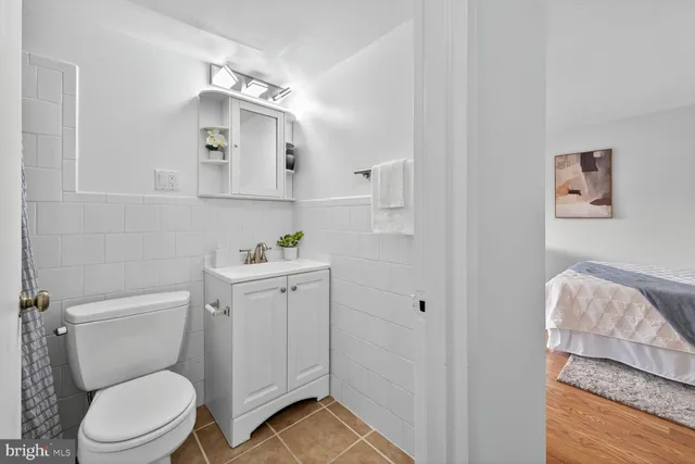 a white toilet sitting next to a bathroom sink