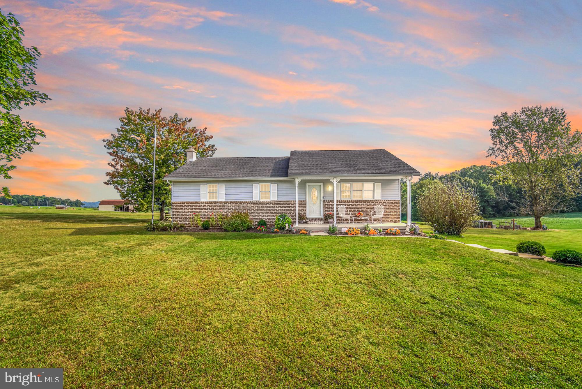 Charming home under a vibrant sunset sky.