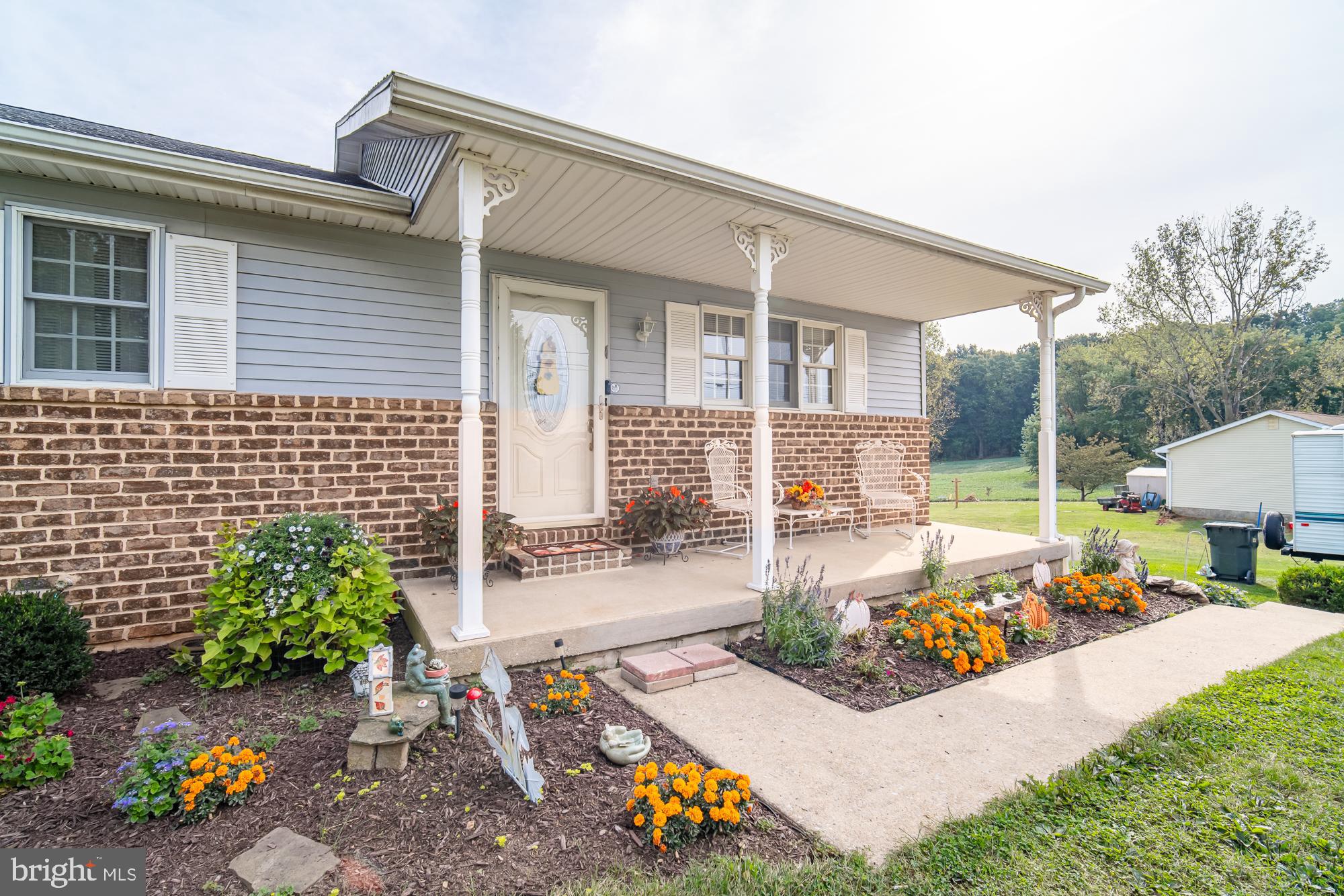 1398 Manor Road Windsor, PA 17366 - Photo 35 of 39 Charming home with vibrant garden blooms.