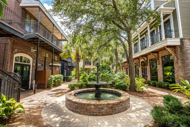 a view of house with a yard and potted plants