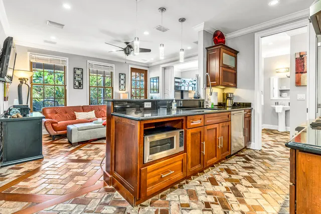 a living room with furniture a flat screen tv and a large window