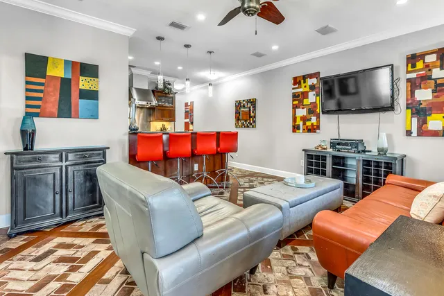 a bedroom with a bed a dresser and chair