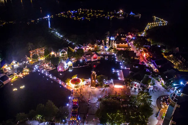an aerial view of a house with a garden and lake view