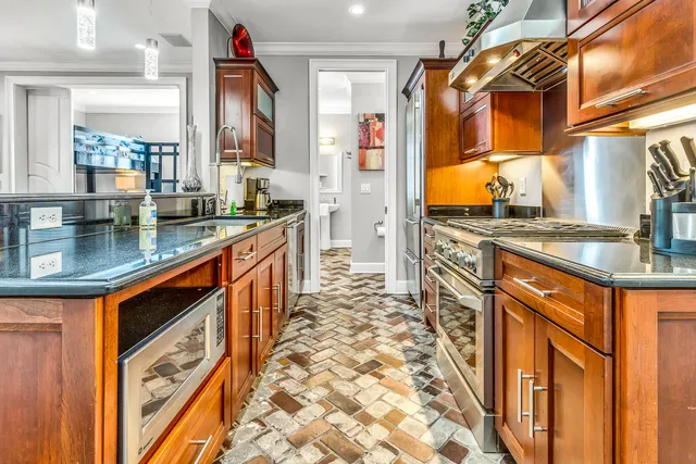 a kitchen with stainless steel appliances granite countertop a stove and a sink