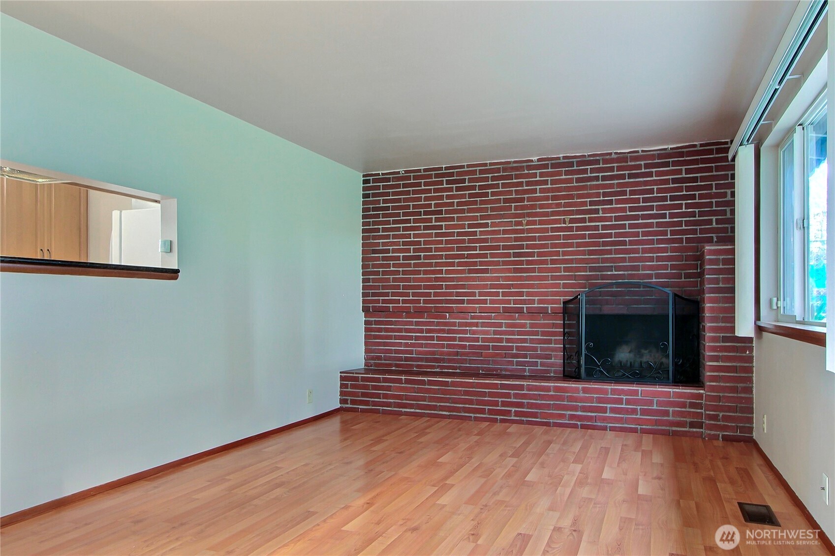1415 South 303rd Street Federal Way, WA 98003 - Photo 2 of 15 a view of a livingroom with wooden floor and a fireplace