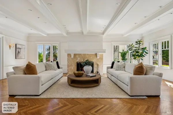 a living room with furniture and large windows