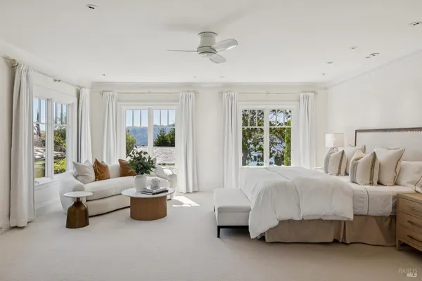 a vase of flowers sitting on a table with wooden floor