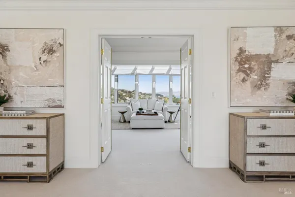 a balcony with wooden floor table and chairs